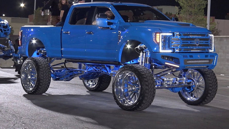 Blue Lifted Ford F-150 with Chrome Wheels at SEMA Show Night Cruise HD wallpaper