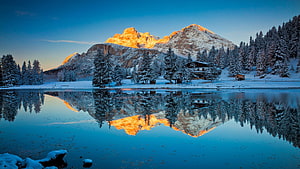 Alpine Lake Reflection at Sunrise with Snow-Capped Peaks and Pine Forest HD wallpaper