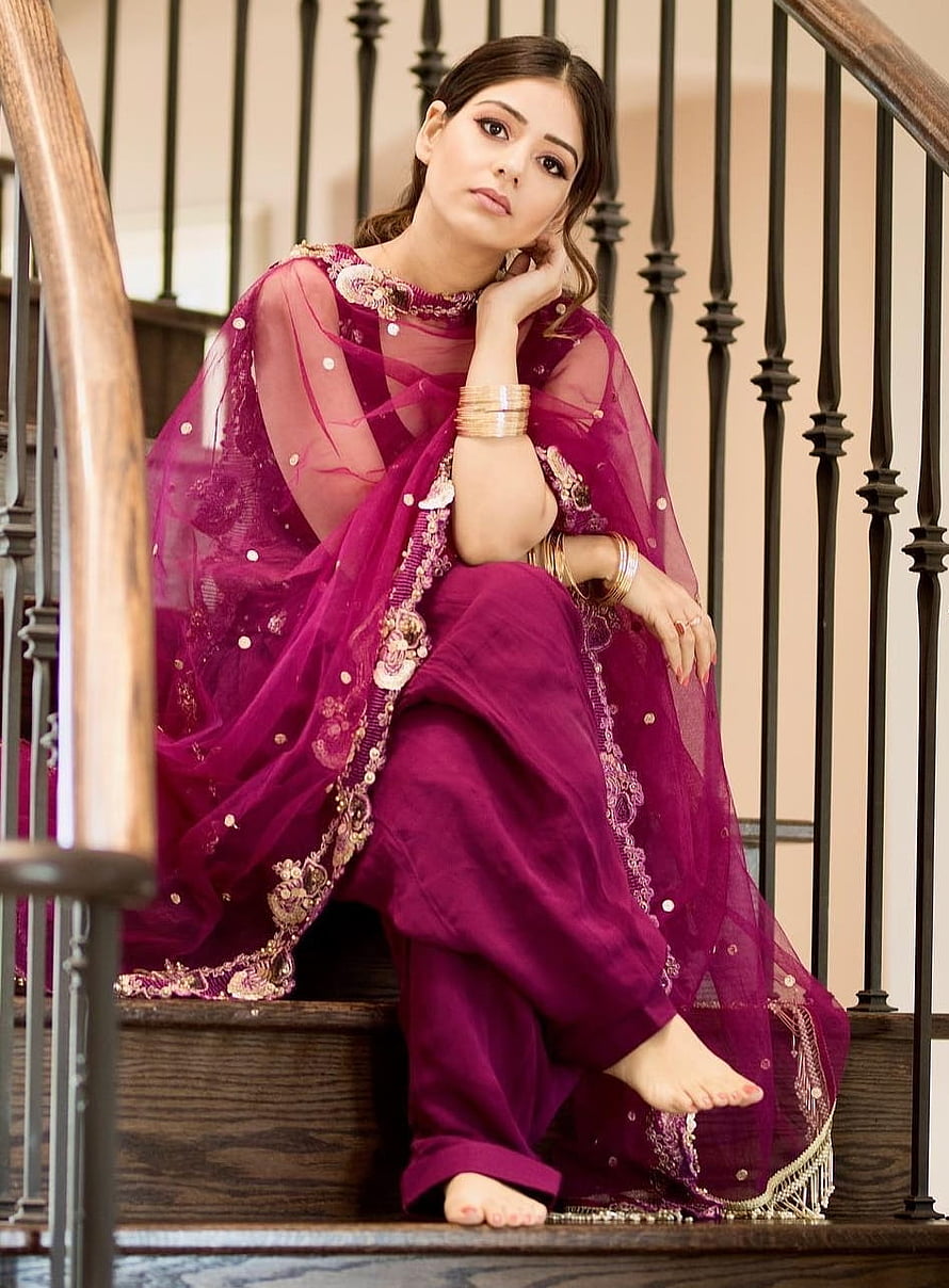 Elegant Woman in Magenta Embroidered Punjabi Suit Sitting on Wooden Staircase HD phone wallpaper