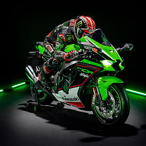 Kawasaki Ninja ZX-10R Superbike with Rider in Full Leathers on Dark Studio Floor HD phone wallpaper