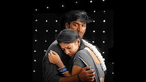 Emotional Indian couple embracing in a dramatic cinematic scene with dark background HD wallpaper