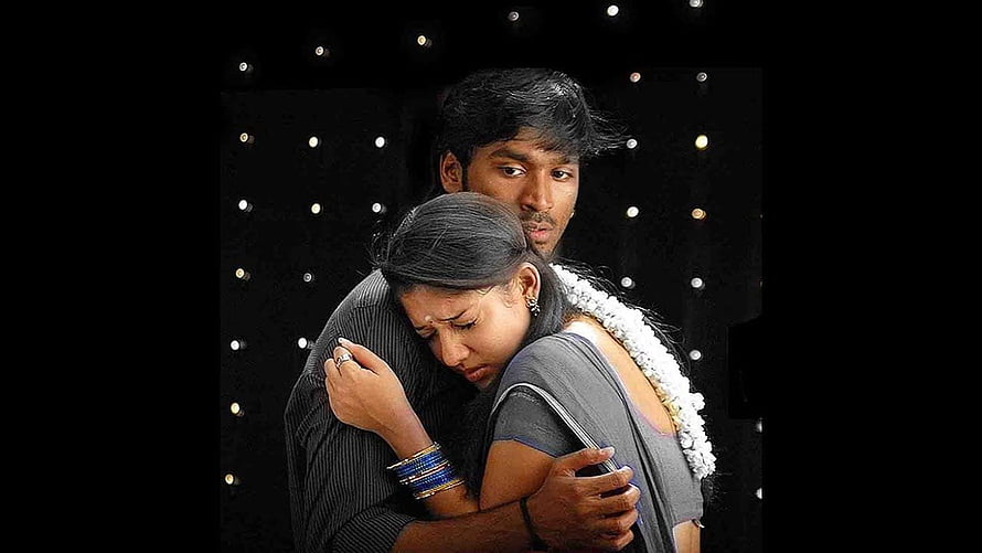 Emotional Indian couple embracing in a dramatic cinematic scene with dark background HD wallpaper