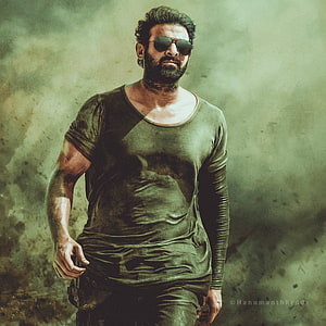Prabhas as Salaar in gritty action pose with sunglasses and olive shirt HD phone wallpaper