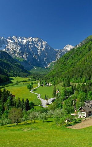 Alpine Valley Landscape With Snow-Capped Peaks And Green Pastures HD phone wallpaper