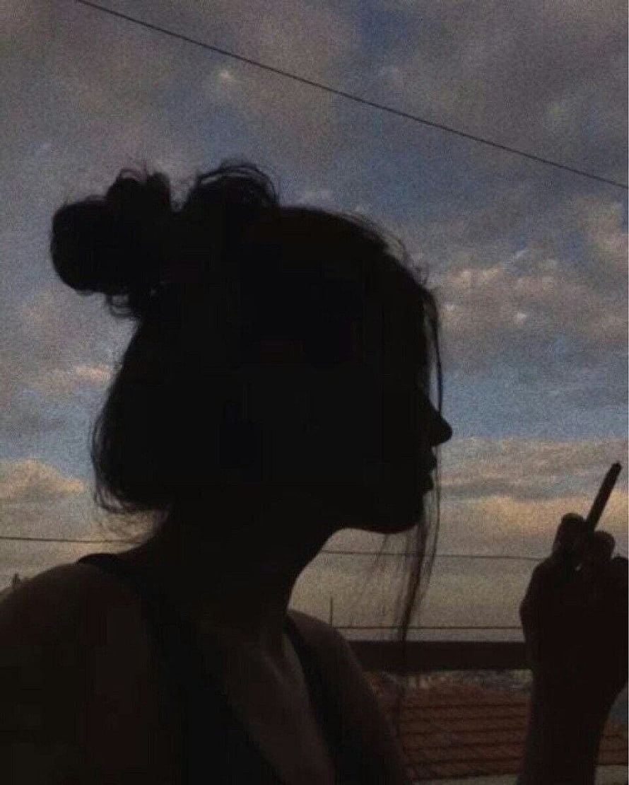 Moody Silhouette of a Woman Smoking Against a Dusk Sky HD phone wallpaper