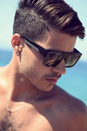 Close-up of a man with a modern fade haircut and sunglasses at the beach HD phone wallpaper