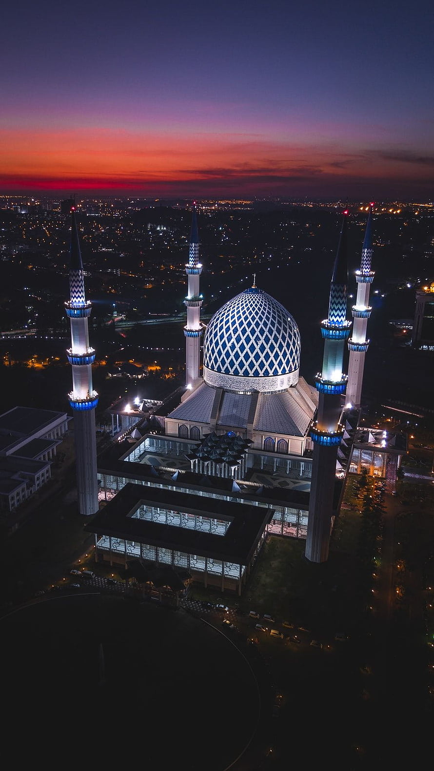 Aerial View of Blue Mosque at Dusk with Illuminated Minarets and City Lights HD phone wallpaper