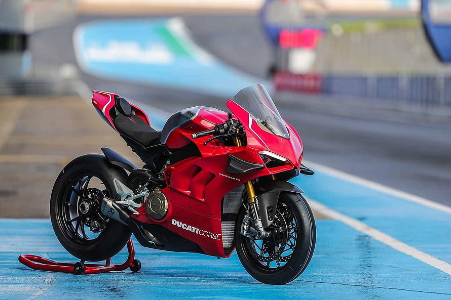 Red Ducati Panigale V4R Superbike Parked on a Blue Racing Circuit Track HD wallpaper