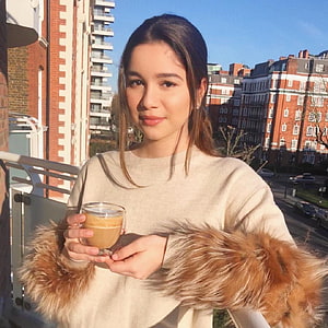Sara Tendulkar Holding Coffee on a Balcony with City View HD phone wallpaper