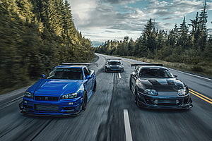 Nissan Supra and Nissan GT-R R34 Racing on a Forest Highway HD wallpaper