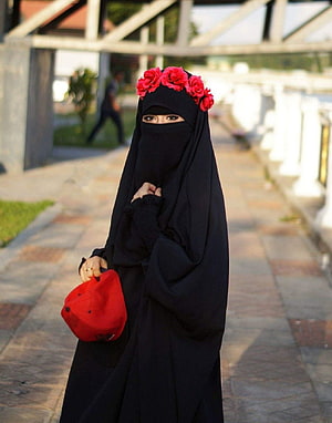 Woman in black niqab with red floral headpiece and matching cap on a paved walkway, 4 Beautiful Cute Girls Islamic for WhatsApp Instagram Profile, instagram girls dp HD phone wallpaper