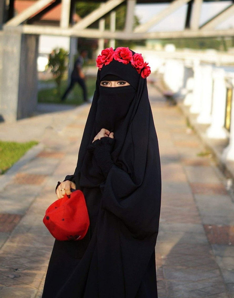 Woman in black niqab with red floral headpiece and matching cap on a paved walkway, 4 Beautiful Cute Girls Islamic for WhatsApp Instagram Profile, instagram girls dp HD phone wallpaper