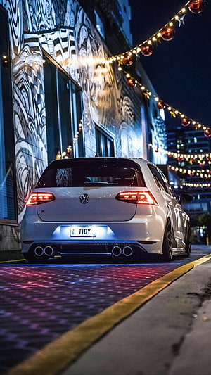 White Volkswagen Golf R Rear View Parked on City Street at Night with String Lights HD phone wallpaper