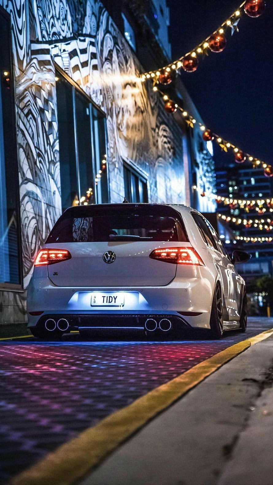 White Volkswagen Golf R Rear View Parked on City Street at Night with String Lights HD phone wallpaper