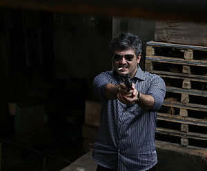 Ajith in Mankatha Aiming Pistol in Dark Warehouse Setting HD wallpaper