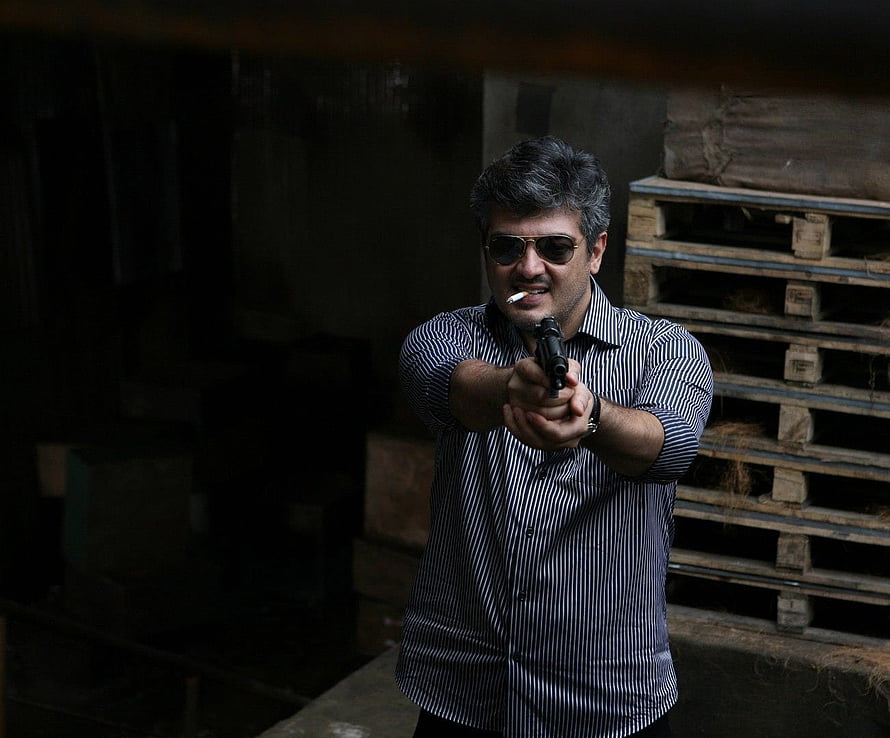 Ajith in Mankatha Aiming Pistol in Dark Warehouse Setting HD wallpaper