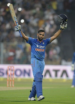 Rohit Sharma Celebrating a Milestone with Bat and Helmet Raised on the Cricket Field HD phone wallpaper