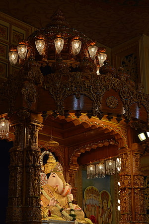 Dagdusheth Ganpati Temple Interior with Ornate Carved Wooden Shrine and Crystal Chandeliers HD phone wallpaper