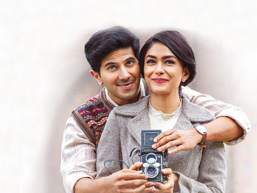 Sita Ramam promotional still featuring couple holding vintage camera HD wallpaper