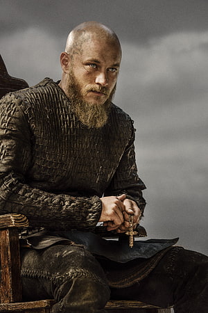 Ragnar Lothbrok in Dark Viking Armor Holding a Cross HD phone wallpaper
