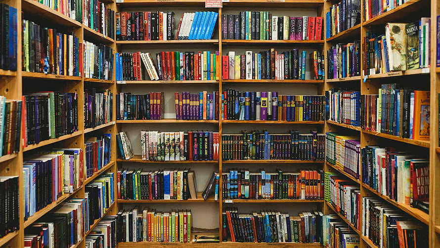 Cozy Home Library Bookshelves Filled With Colorful Hardcover Books HD wallpaper