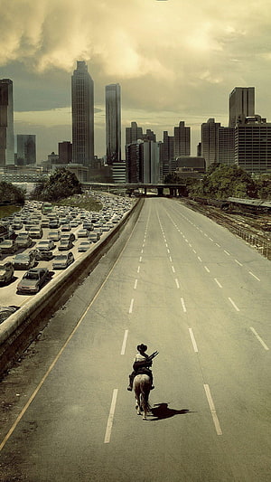 The Walking Dead Lone Rider on Empty Highway Amidst City Traffic Jam HD phone wallpaper