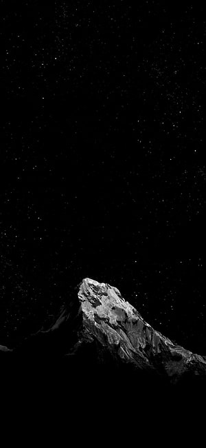 Snow-Capped Mountain Peak Against a Starry Night Sky in Monochrome HD phone wallpaper