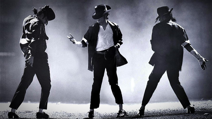 Michael Jackson performing in a black hat and jacket on a smoky stage HD wallpaper