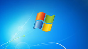 Windows 7 Default Blue Desktop Background with Classic Four-Pane Logo and Light Streaks HD wallpaper