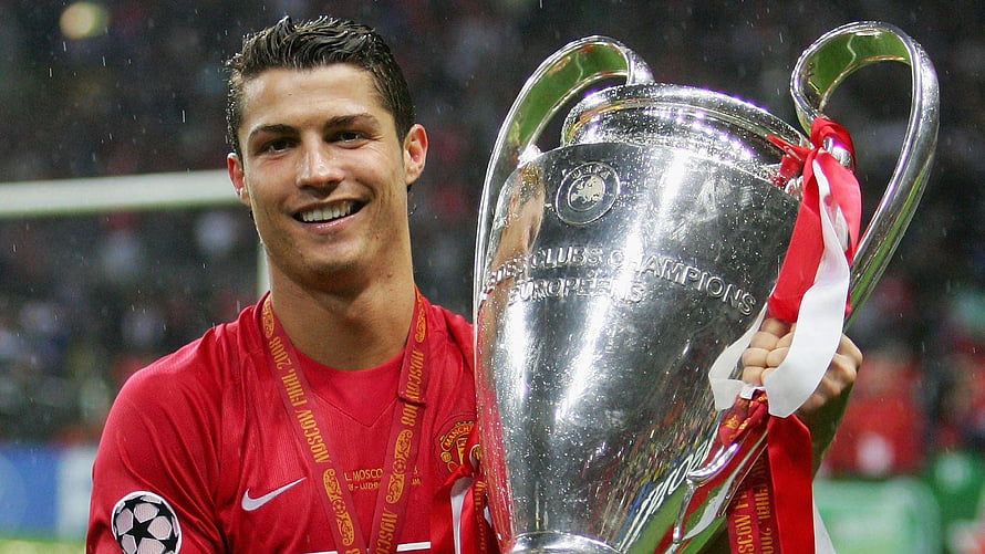 Cristiano Ronaldo holding the UEFA Champions League trophy in a Manchester United kit HD wallpaper