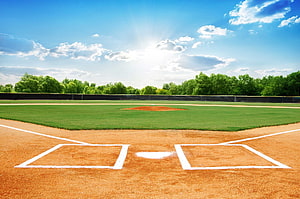 Sunlit Little League Baseball Field With Home Plate And Pitcher's Mound HD wallpaper