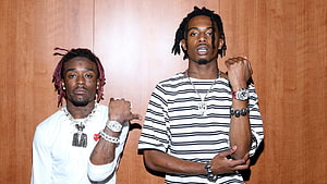 Lil Uzi Vert and Playboi Carti posing together in striped and white outfits HD wallpaper
