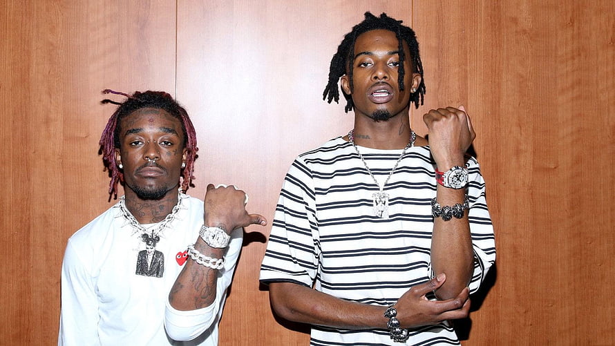 Lil Uzi Vert and Playboi Carti posing together in striped and white outfits HD wallpaper