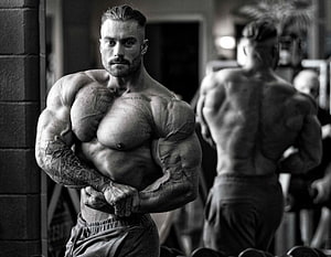 Chris Bumstead Bodybuilder Posing in Black and White Gym Portrait HD wallpaper