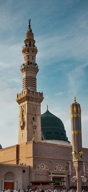 Grand Mosque Minaret and Green Dome Against a Blue Sky with Crowds Below HD phone wallpaper