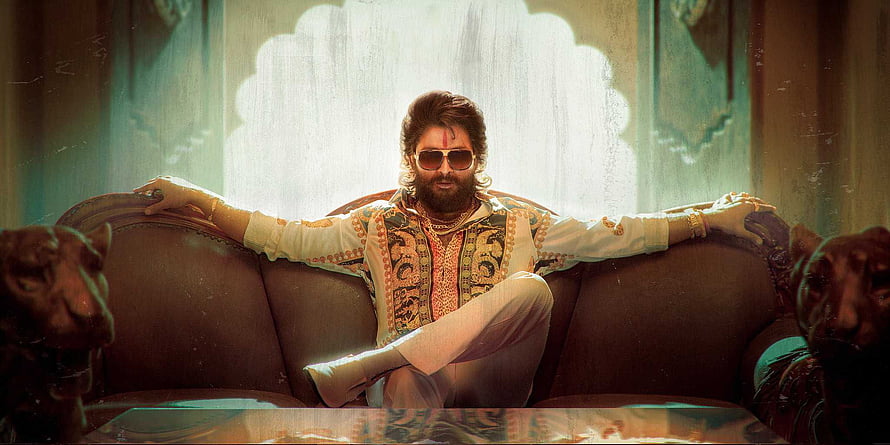 Pushpa Raj in ornate kurta and sunglasses seated on a vintage sofa with lion statues HD wallpaper