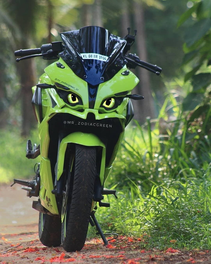 Custom Green RS 200 Motorcycle with Aggressive Face Design in Forest Setting HD phone wallpaper