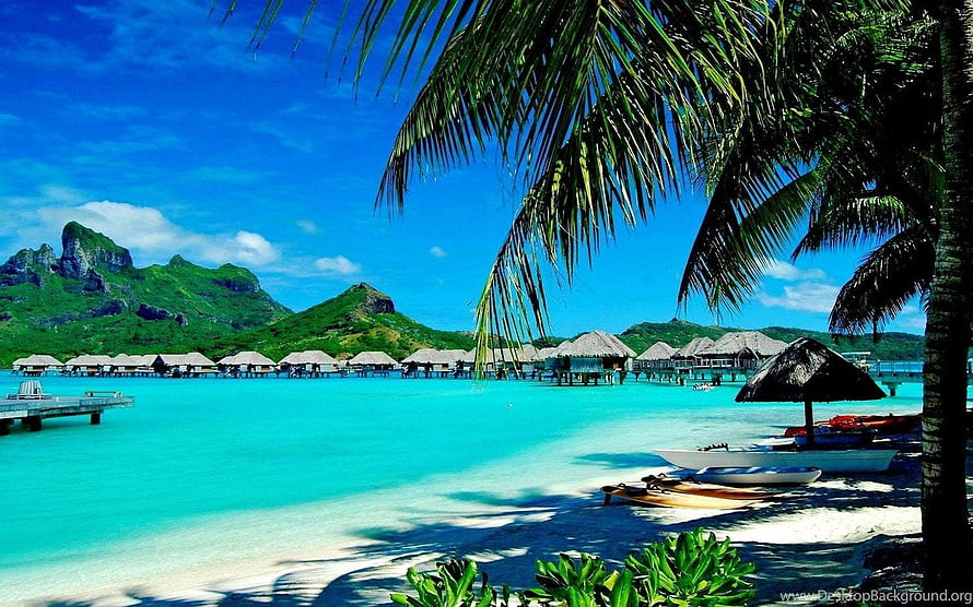 Tropical Overwater Bungalows on a White Sand Beach with Turquoise Water and Lush Green Mountains HD wallpaper