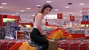 Jennifer Connelly Riding a Toy Horse in a Supermarket Aisle HD wallpaper