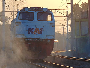 KAI Electric Locomotive on Curved Track at Golden Hour in Indonesia HD wallpaper