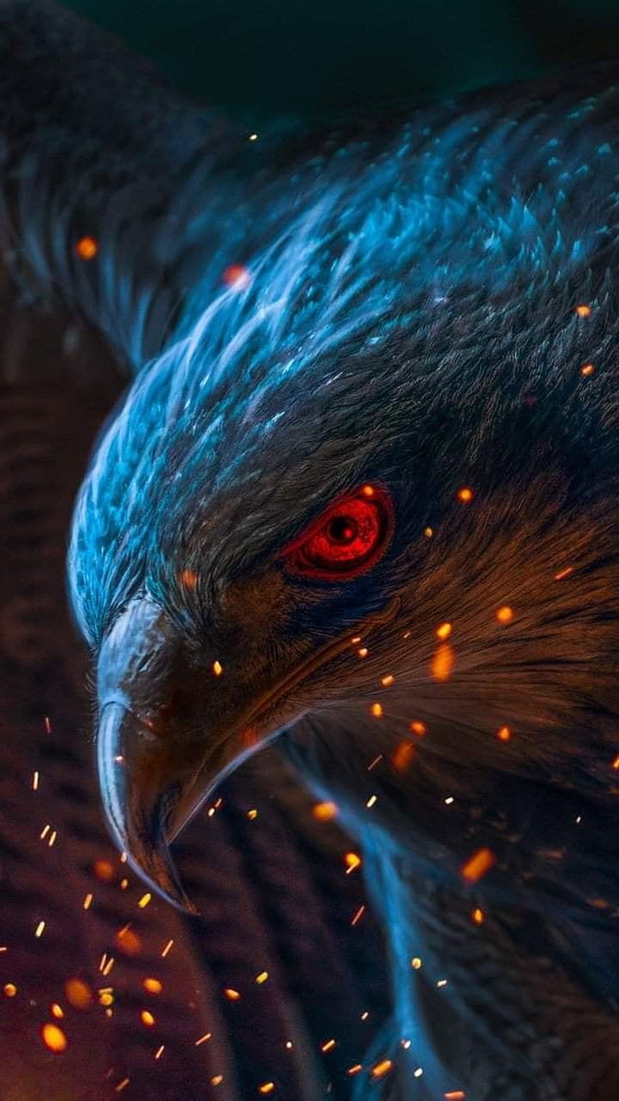 Close-up of a fierce eagle with glowing red eyes and floating embers in a dark, cinematic setting HD phone wallpaper