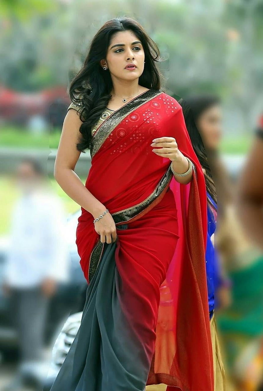 Nivetha Thomas in a vibrant red and black sari with gold border HD phone wallpaper