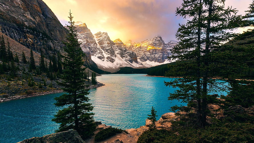 Turquoise Mountain Lake at Golden Hour with Snow-Capped Peaks and Evergreen Forest HD wallpaper