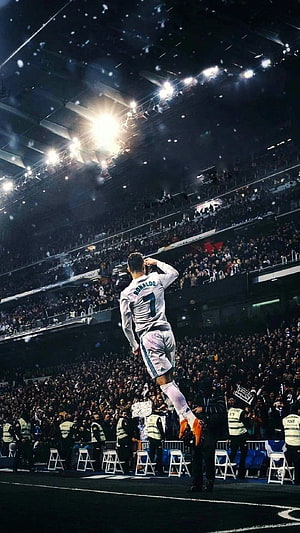 Cristiano Ronaldo Mid-Air Goal Celebration in White Kit Under Stadium Floodlights HD phone wallpaper