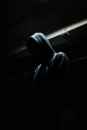 Mysterious Hooded Figure in Dramatic Low-Key Lighting HD phone wallpaper