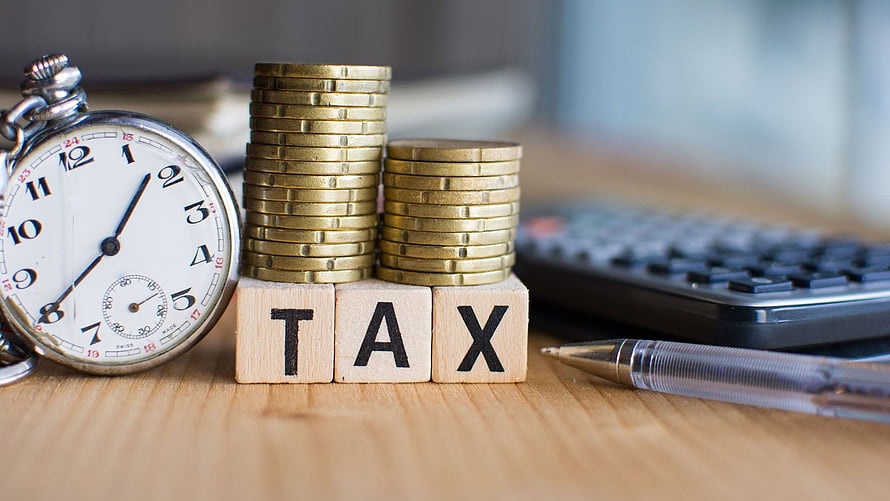 Income Tax Planning Concept with Stacked Coins, Stopwatch, and Calculator on Desk HD wallpaper