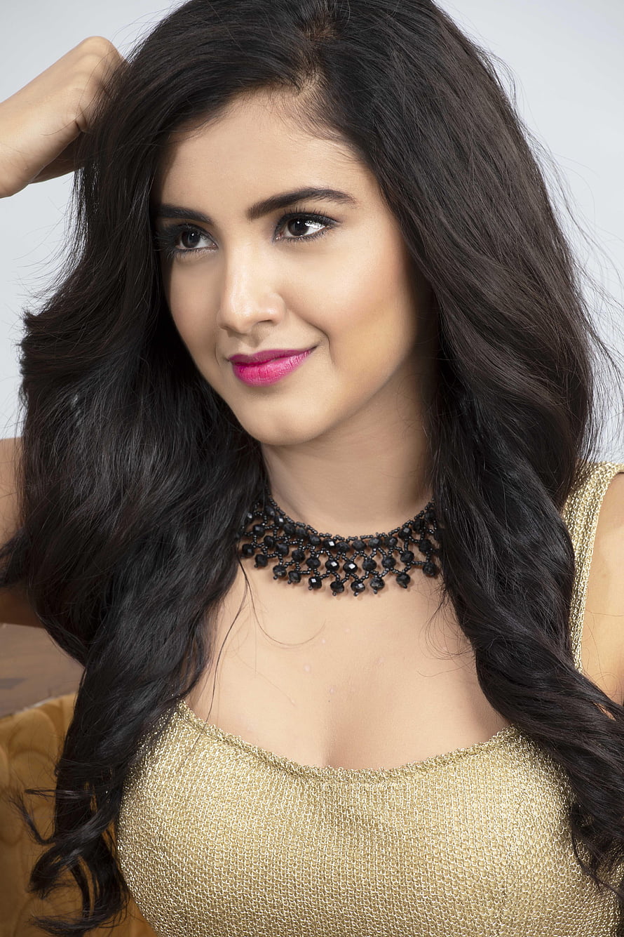 Malvika Sharma in a Gold Top with Black Beaded Necklace and Long Wavy Hair HD phone wallpaper