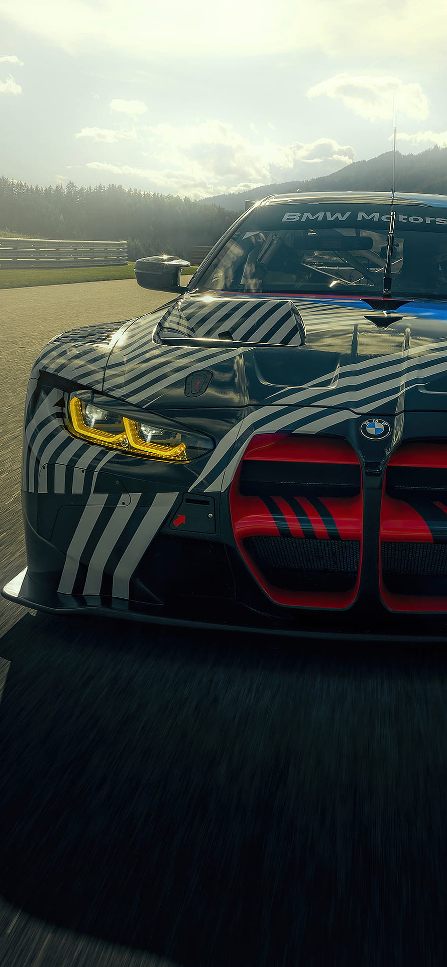 2021 BMW M4 GT3 Race Car Front View on Track with Striped Livery and Red Grille HD phone wallpaper