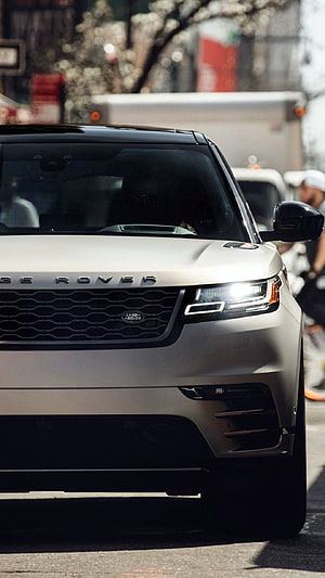 Silver Range Rover Velar Front Grille and Headlight Detail on a City Street HD phone wallpaper