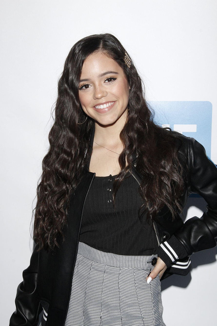 Jenna Ortega in Black Leather Jacket and Houndstooth Skirt at Red Carpet Event HD phone wallpaper